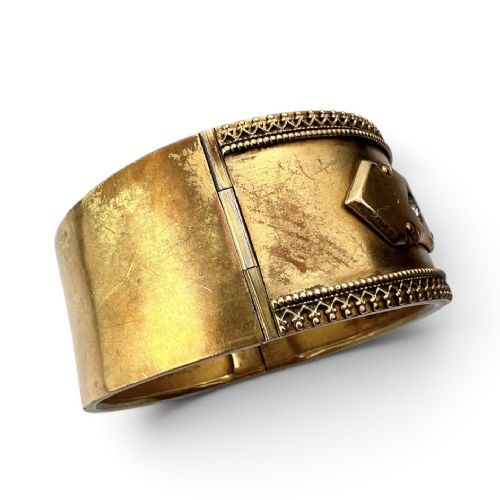 A wide Victorian Etruscan Revival gold hinged bangle decorated with intricate beadwork borders and star-set gemstones across a central band. View III