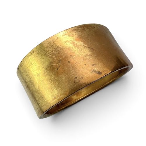 A wide Victorian Etruscan Revival gold hinged bangle decorated with intricate beadwork borders and star-set gemstones across a central band. View V