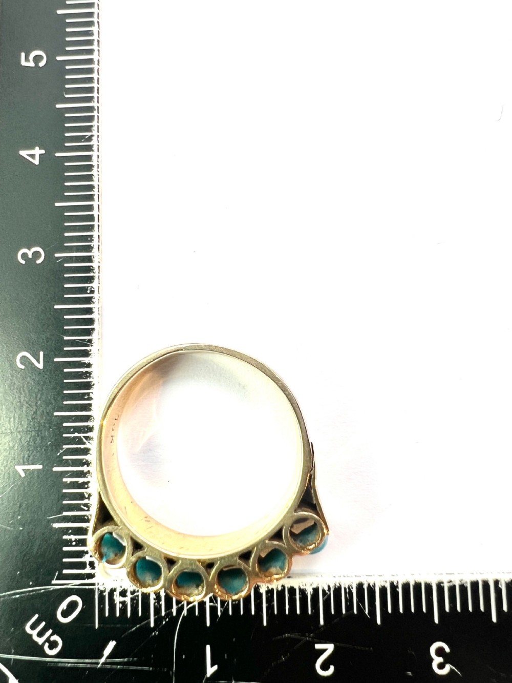 An 18ct yellow gold modernist ring set with six round turquoise cabochons within a textured openwork gallery. View VIII
