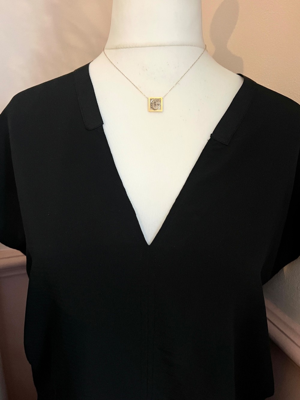 A square 9ct yellow gold Victorian ribbon slider pendant featuring a gothic letter E set with seed pearls. View III