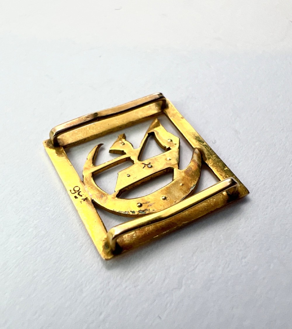A square 9ct yellow gold Victorian ribbon slider pendant featuring a gothic letter E set with seed pearls. View V