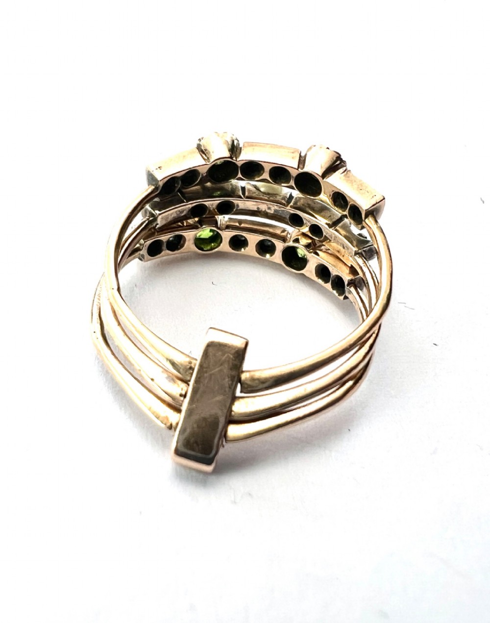 An Edwardian multi-band harem ring crafted in gold and silver, set with green and blue gemstones, diamonds, and a central pearl. View IV