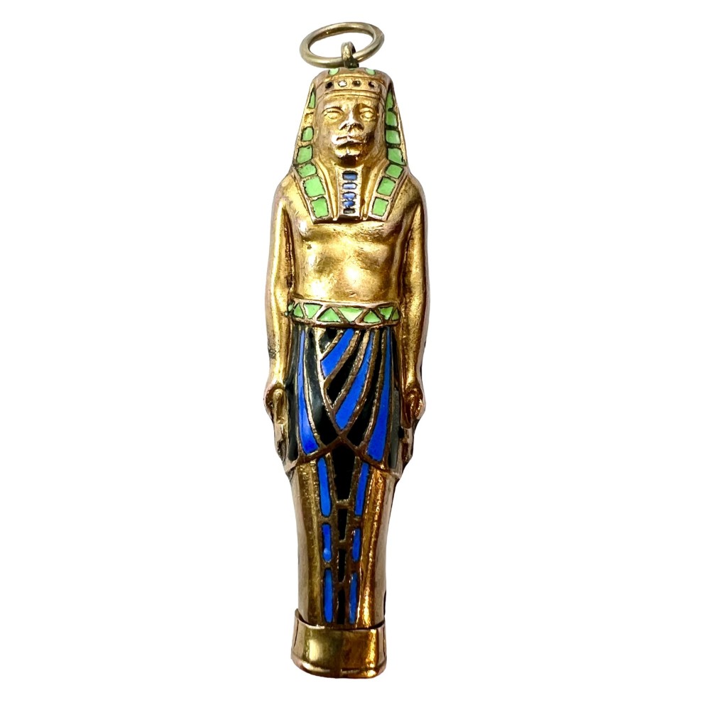 An antique gilt metal and enamel Egyptian Revival sarcophagus pendant featuring a pharaoh figure with blue and green enamelled detailing, designed as a mechanical propelling pencil.