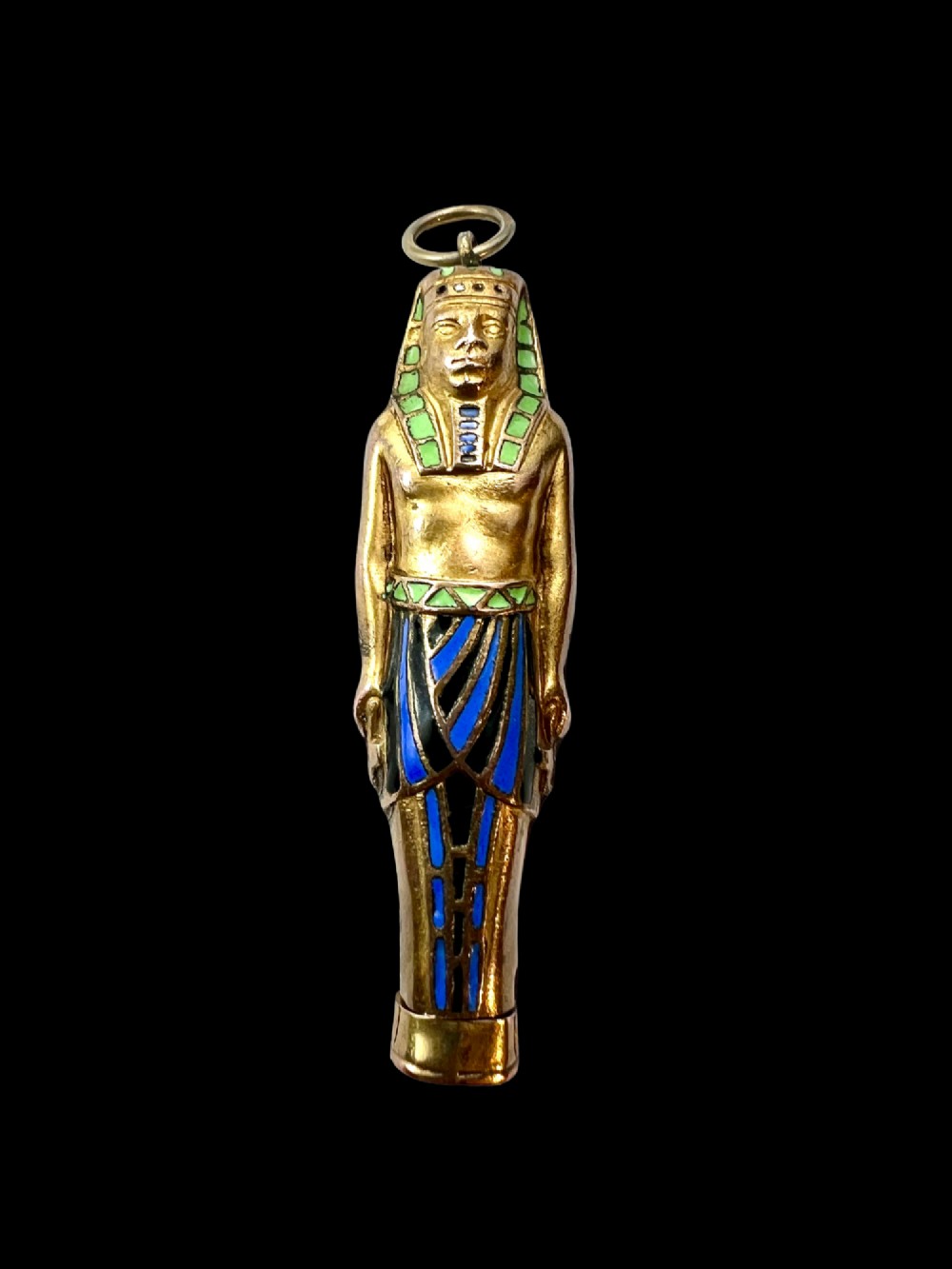 An antique gilt metal and enamel Egyptian Revival sarcophagus pendant featuring a pharaoh figure with blue and green enamelled detailing, designed as a mechanical propelling pencil. View II
