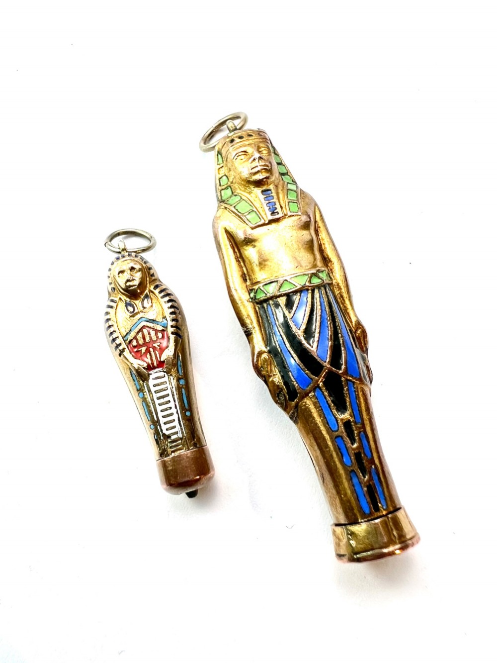 An antique gilt metal and enamel Egyptian Revival sarcophagus pendant featuring a pharaoh figure with blue and green enamelled detailing, designed as a mechanical propelling pencil. View XI