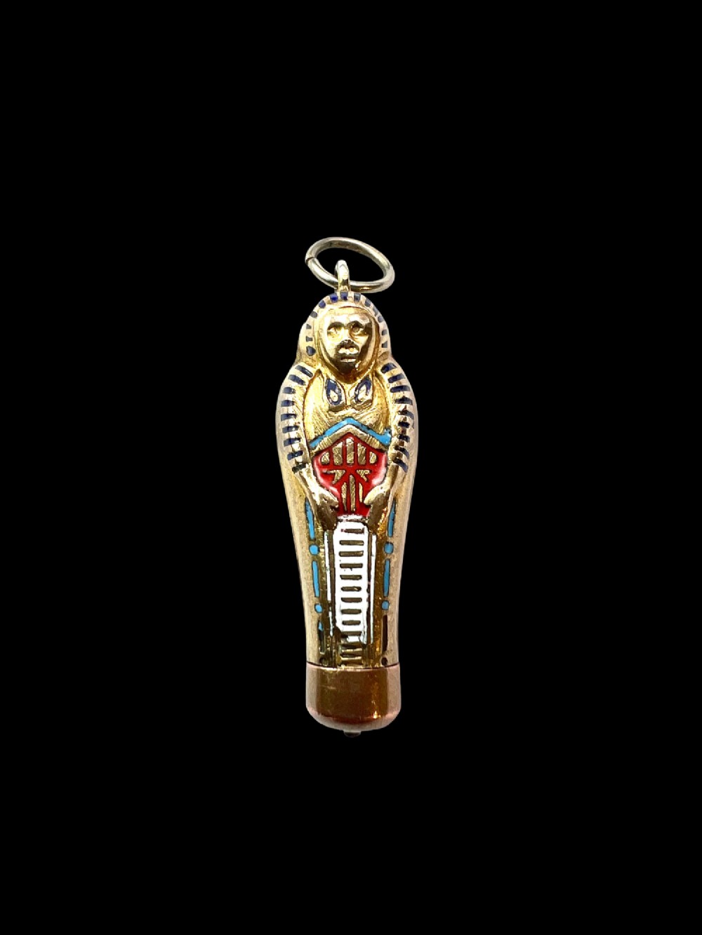 An antique gilt metal sarcophagus-shaped propelling pencil pendant featuring colourful blue, red, and white enamel decoration with a top jump ring. View II