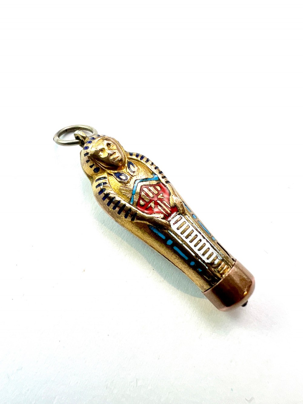 An antique gilt metal sarcophagus-shaped propelling pencil pendant featuring colourful blue, red, and white enamel decoration with a top jump ring. View IV
