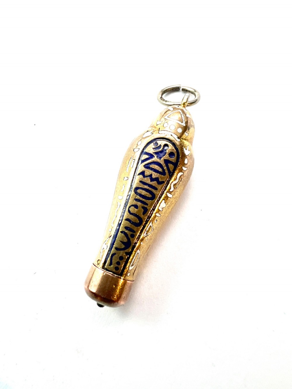 An antique gilt metal sarcophagus-shaped propelling pencil pendant featuring colourful blue, red, and white enamel decoration with a top jump ring. View V