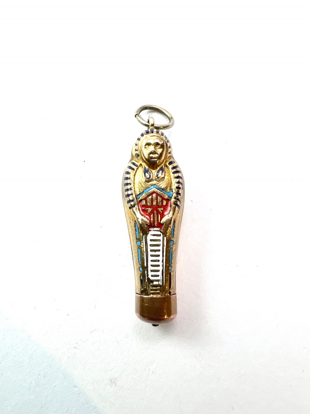 An antique gilt metal sarcophagus-shaped propelling pencil pendant featuring colourful blue, red, and white enamel decoration with a top jump ring. View VI