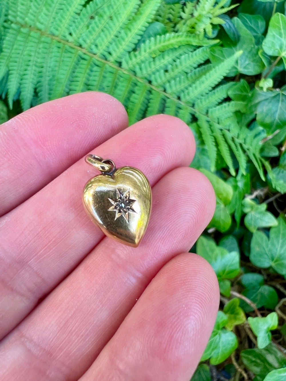 A three-dimensional 9ct gold Victorian heart pendant featuring intricate chased scrollwork and a top suspension ring. View VII