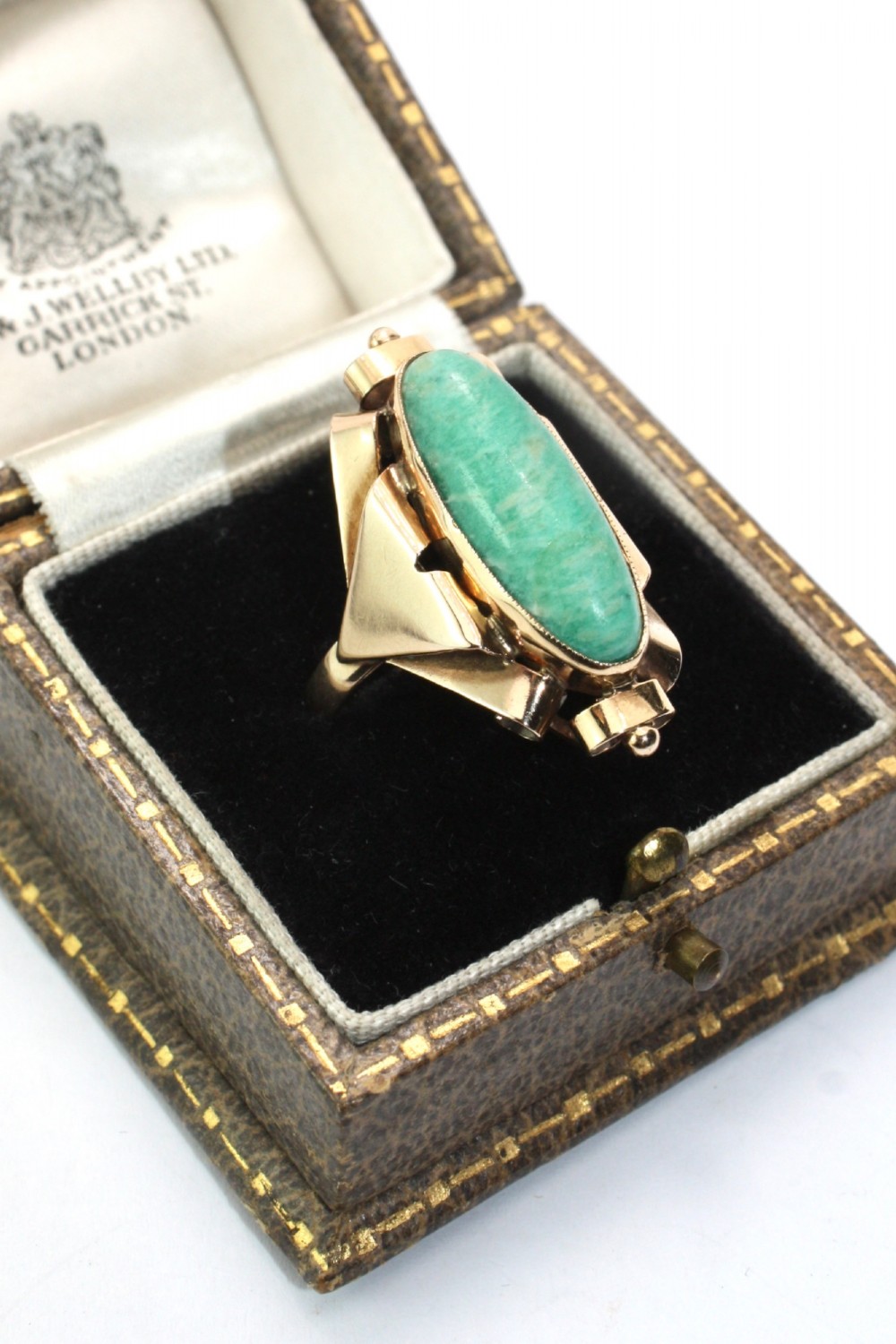 A 1940s gold cocktail ring featuring an elongated green aventurine cabochon set within sculptural scrolled side accents. View III