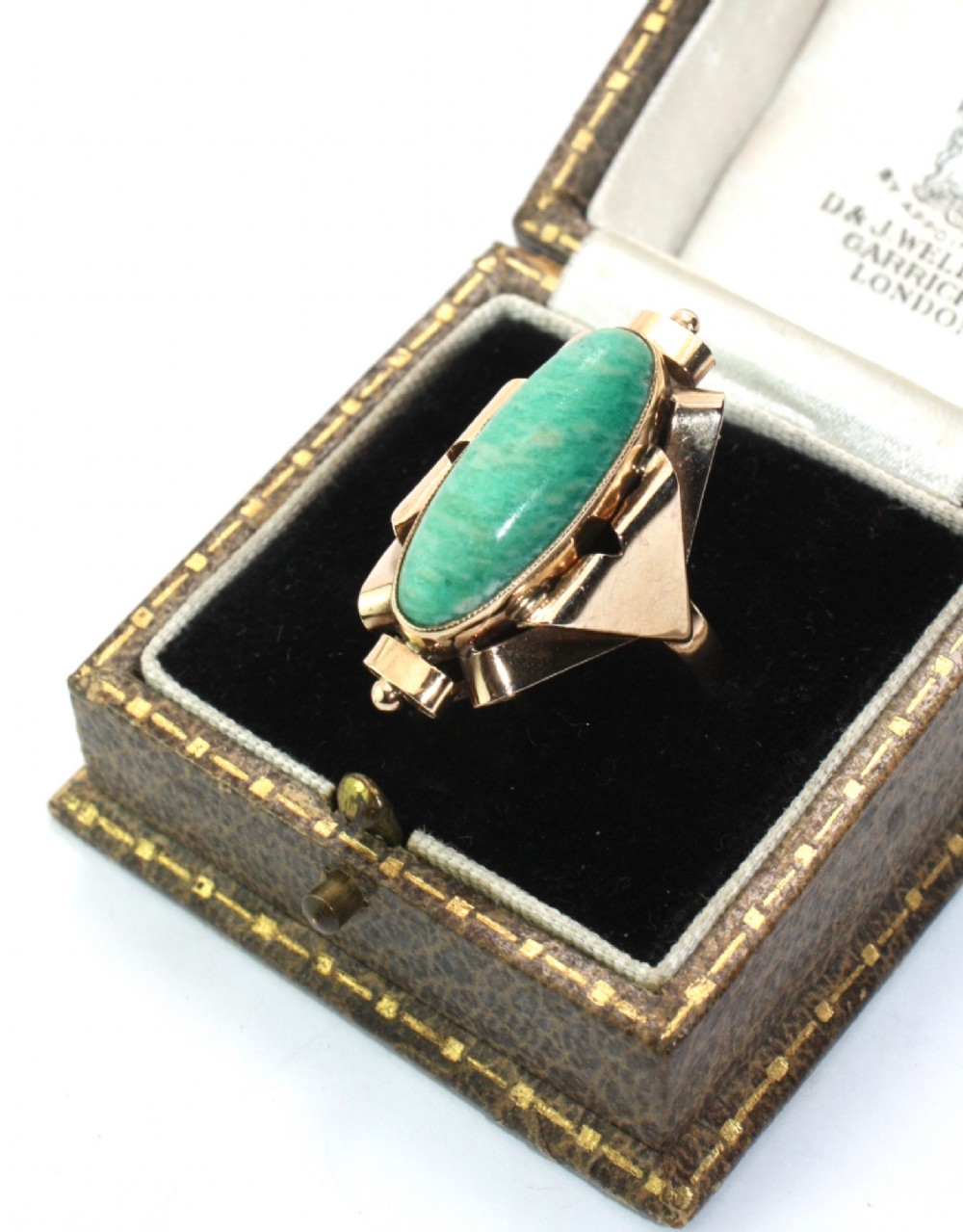 A 1940s gold cocktail ring featuring an elongated green aventurine cabochon set within sculptural scrolled side accents. View IV