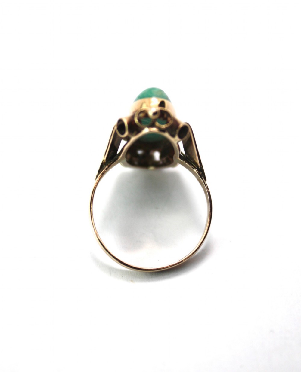 A 1940s gold cocktail ring featuring an elongated green aventurine cabochon set within sculptural scrolled side accents. View VI