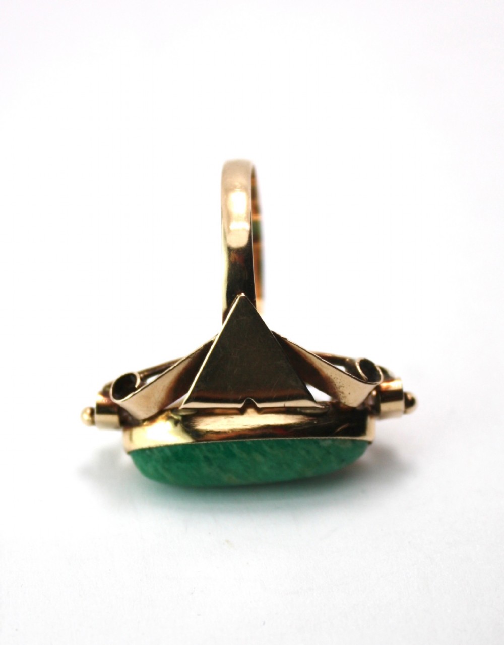 A 1940s gold cocktail ring featuring an elongated green aventurine cabochon set within sculptural scrolled side accents. View VII