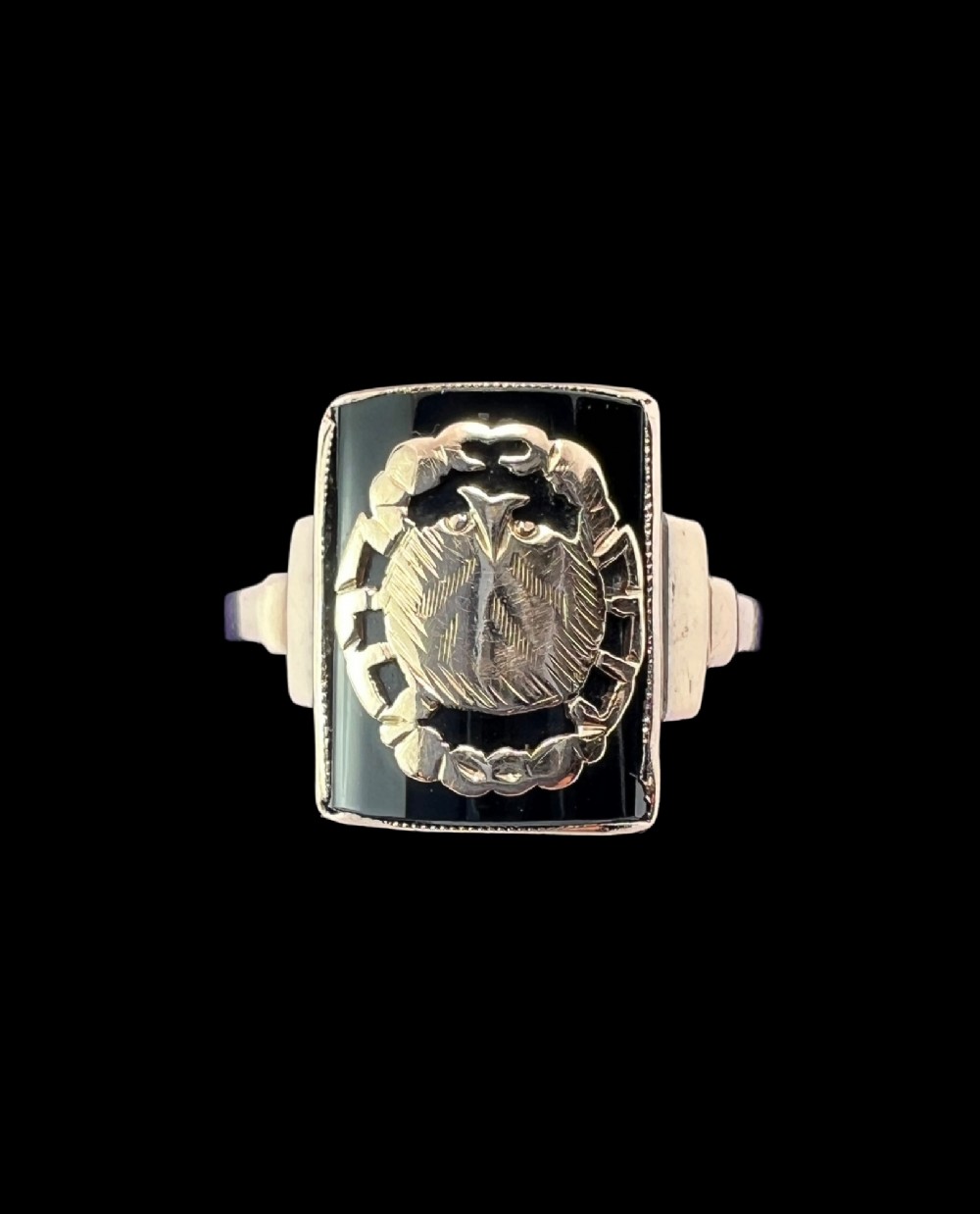 A rectangular 9ct gold ring set with a flat black onyx plaque featuring an detailed gold crab motif for the Cancer zodiac sign. View II