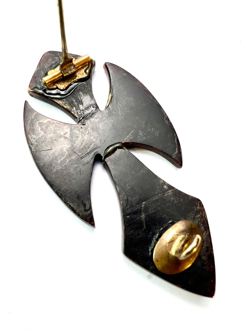 A Victorian cross brooch crafted from dark tortoiseshell with gold and silver pique floral inlays. View III
