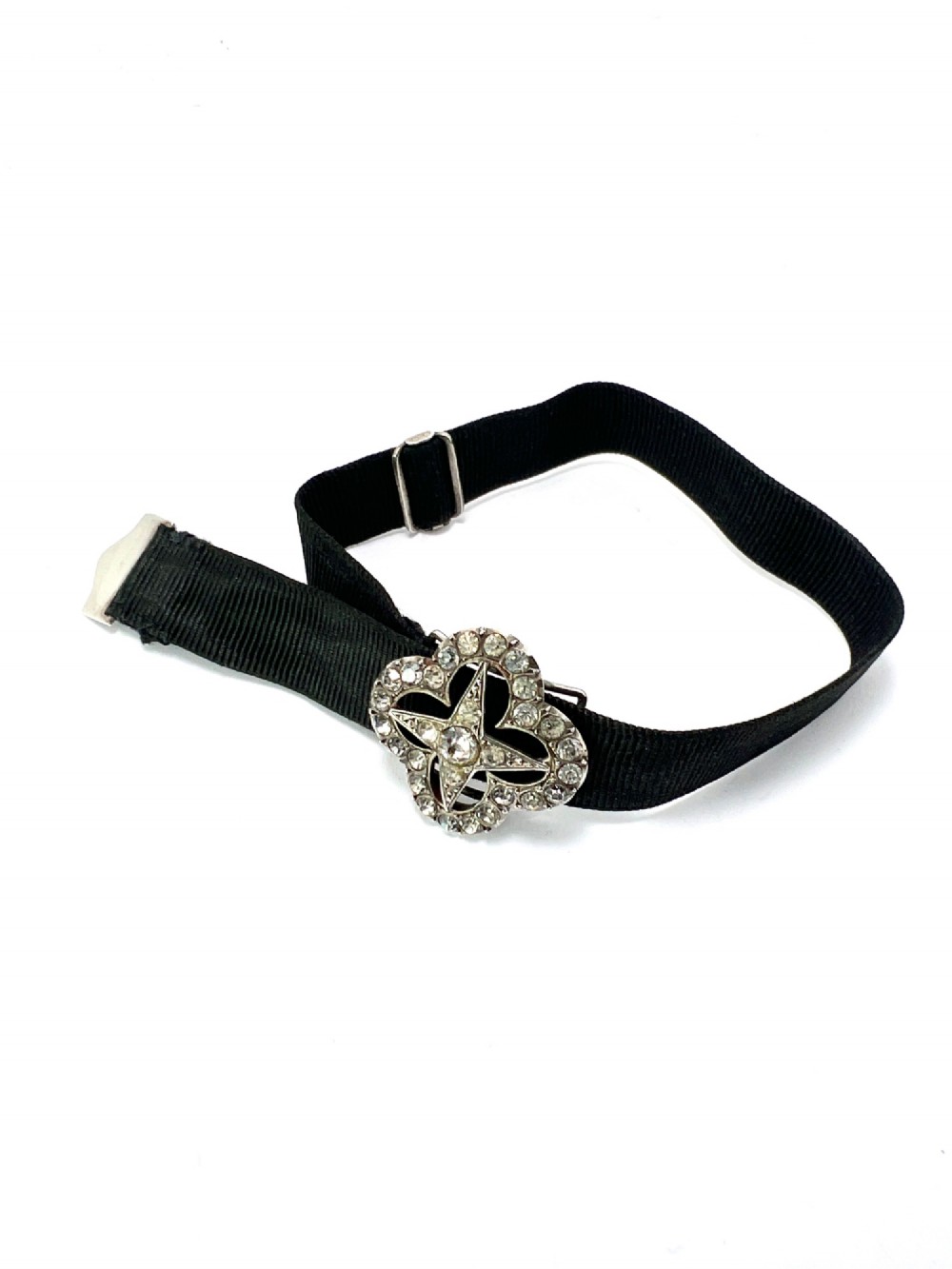 An antique silver ribbon slider bracelet featuring a star-shaped paste central motif on a black grosgrain ribbon. View III