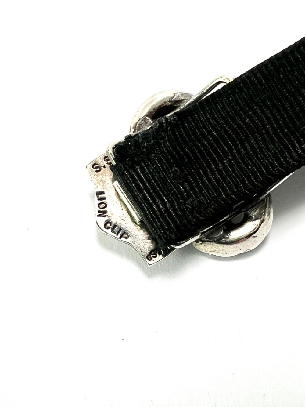 An antique silver ribbon slider bracelet featuring a star-shaped paste central motif on a black grosgrain ribbon. View IV