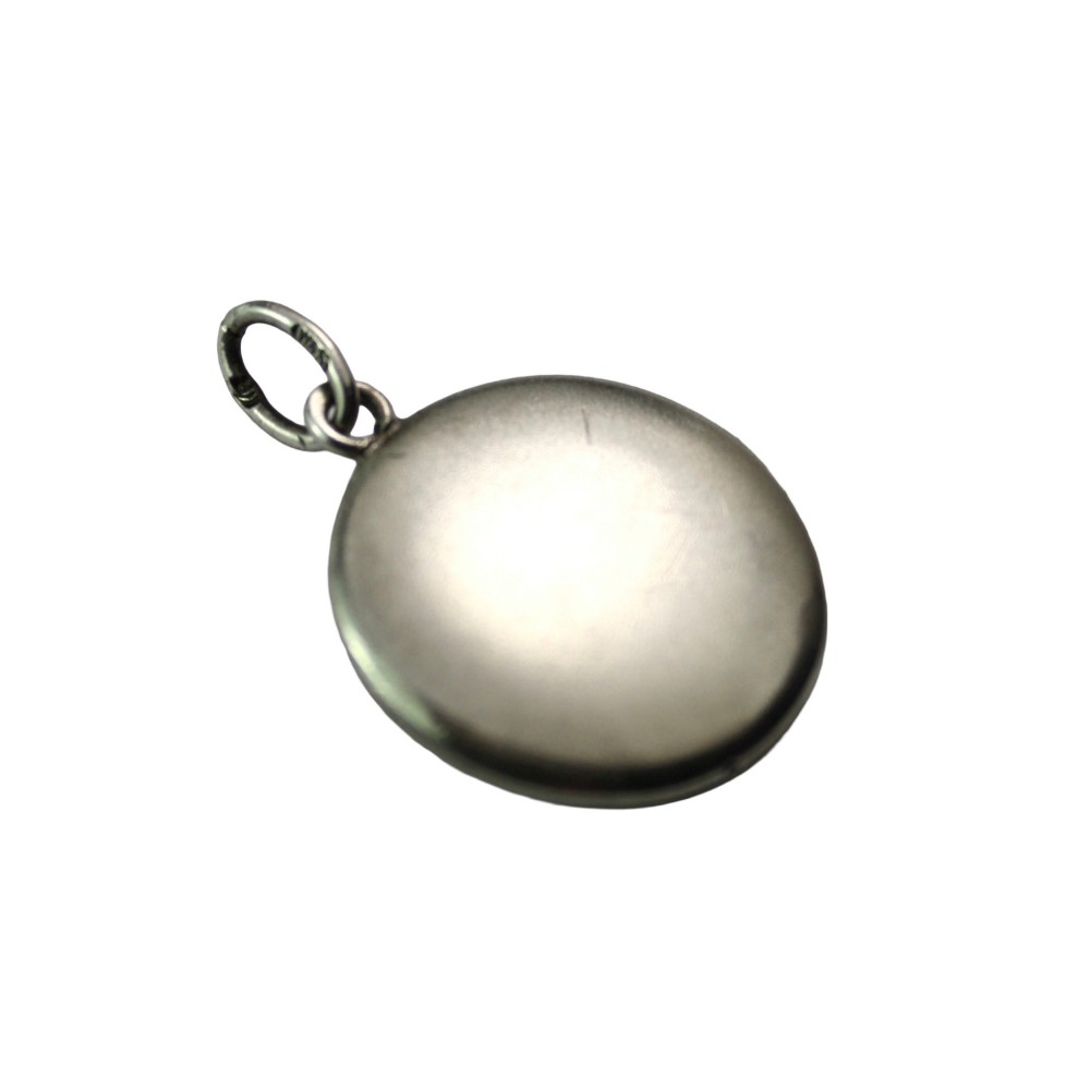 A circular silver Art Nouveau pendant featuring engraved line details, a central seed pearl, and a flush-set red paste stone. View II
