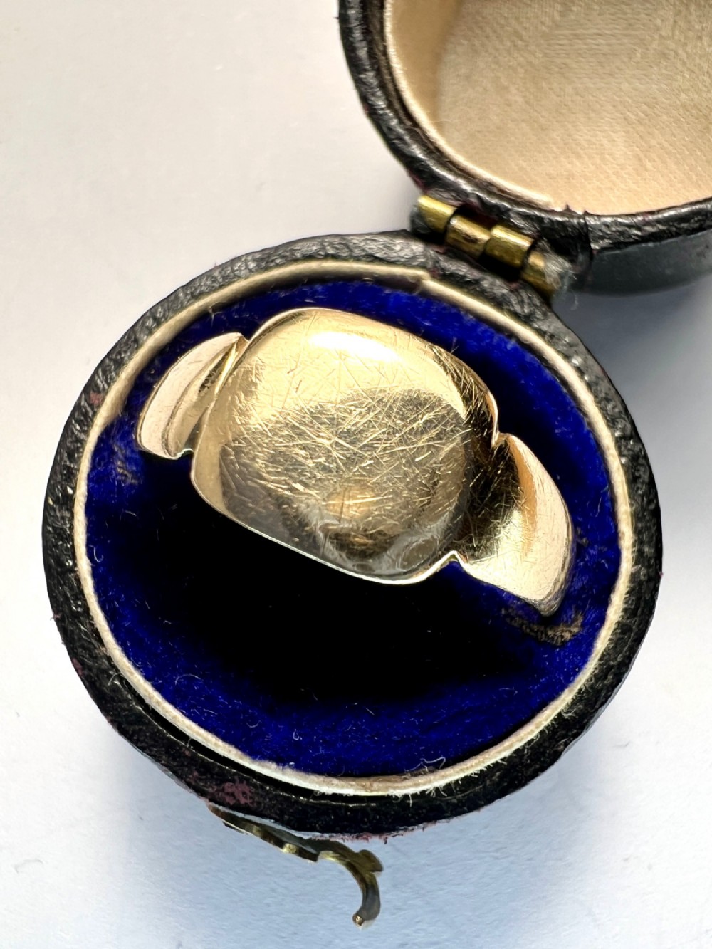 A vintage 9ct yellow gold signet ring featuring a textured rectangular face and a hallmarked inner band. View V