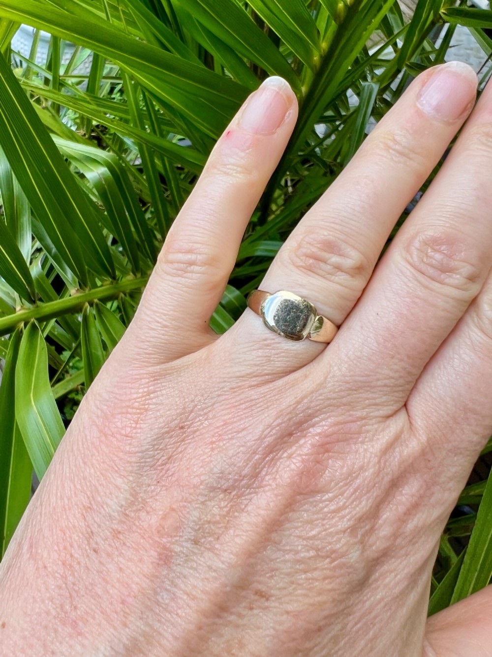 A vintage 9ct yellow gold signet ring featuring a textured rectangular face and a hallmarked inner band. View VI