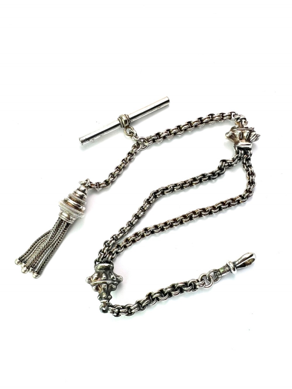 An antique silver Albertina watch chain featuring woven multi-strand links, a T-bar attachment, decorative sliding motifs, a swivel clasp, and a hanging tassel fob. View II