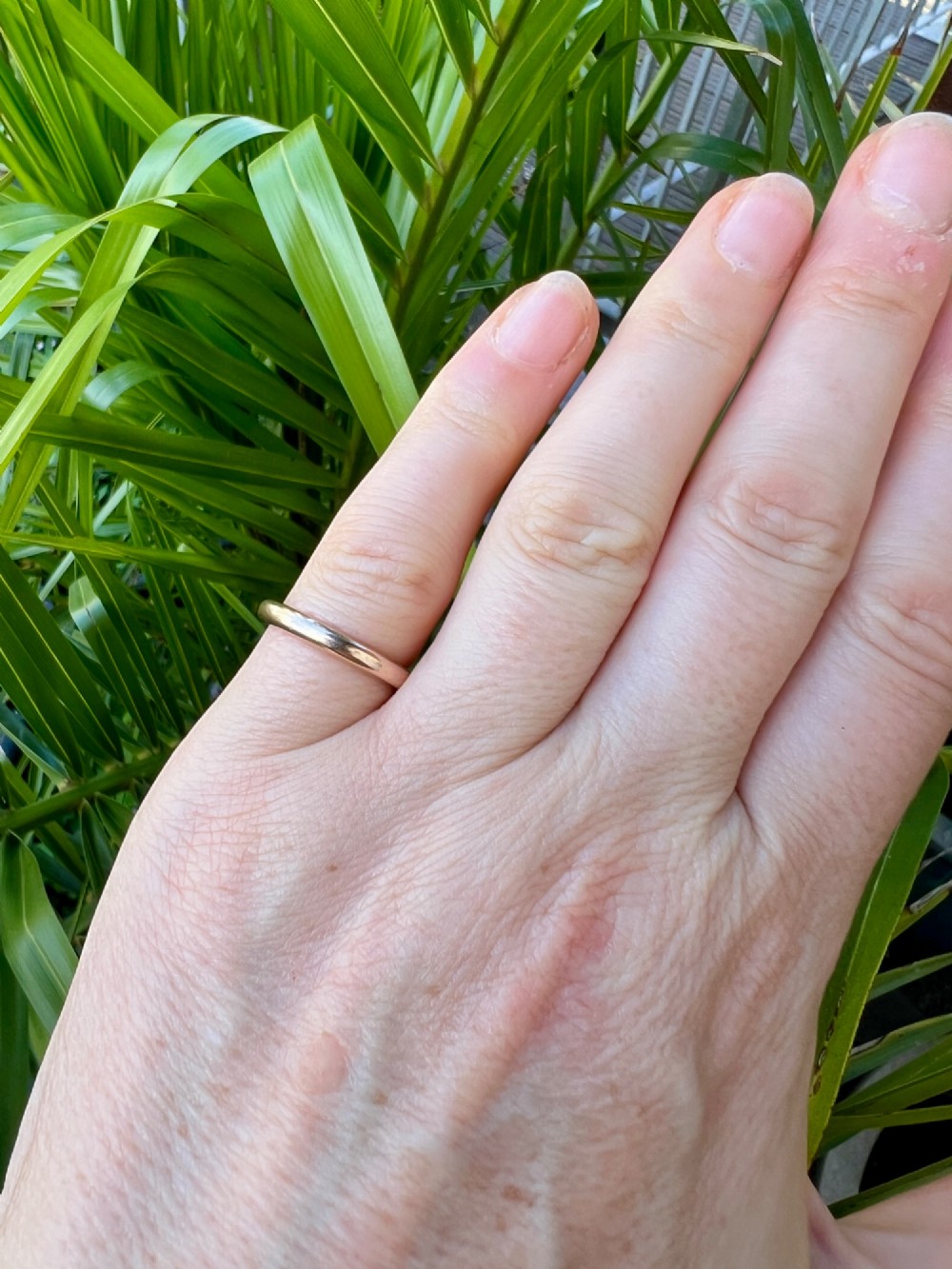 A smooth plain 9ct gold ring displaying visible official hallmarks stamped on the interior band. View VII
