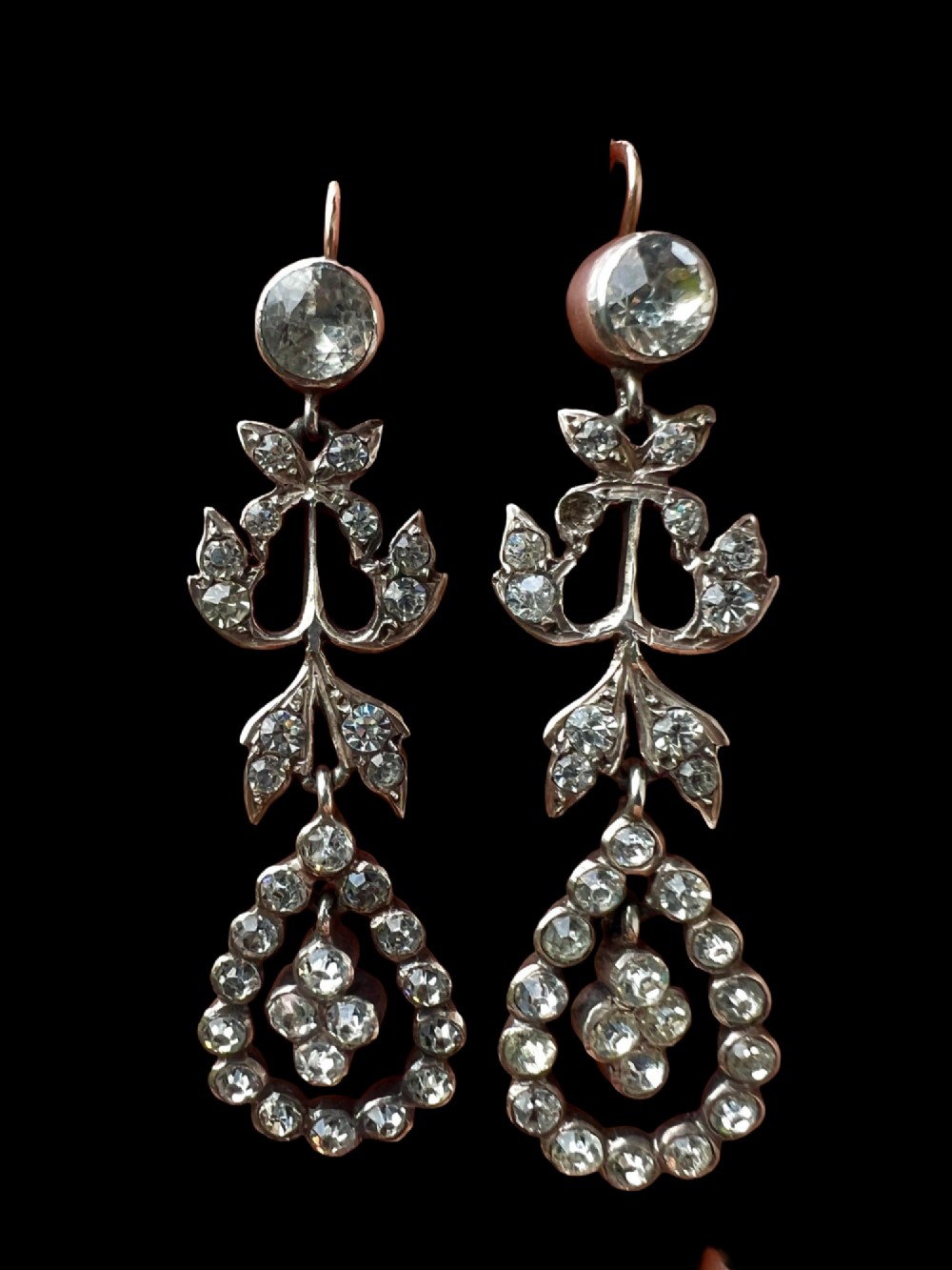 Pair of nineteenth-century silver drop earrings set with clear faceted paste glass stones in an articulated chandelier motif. View II
