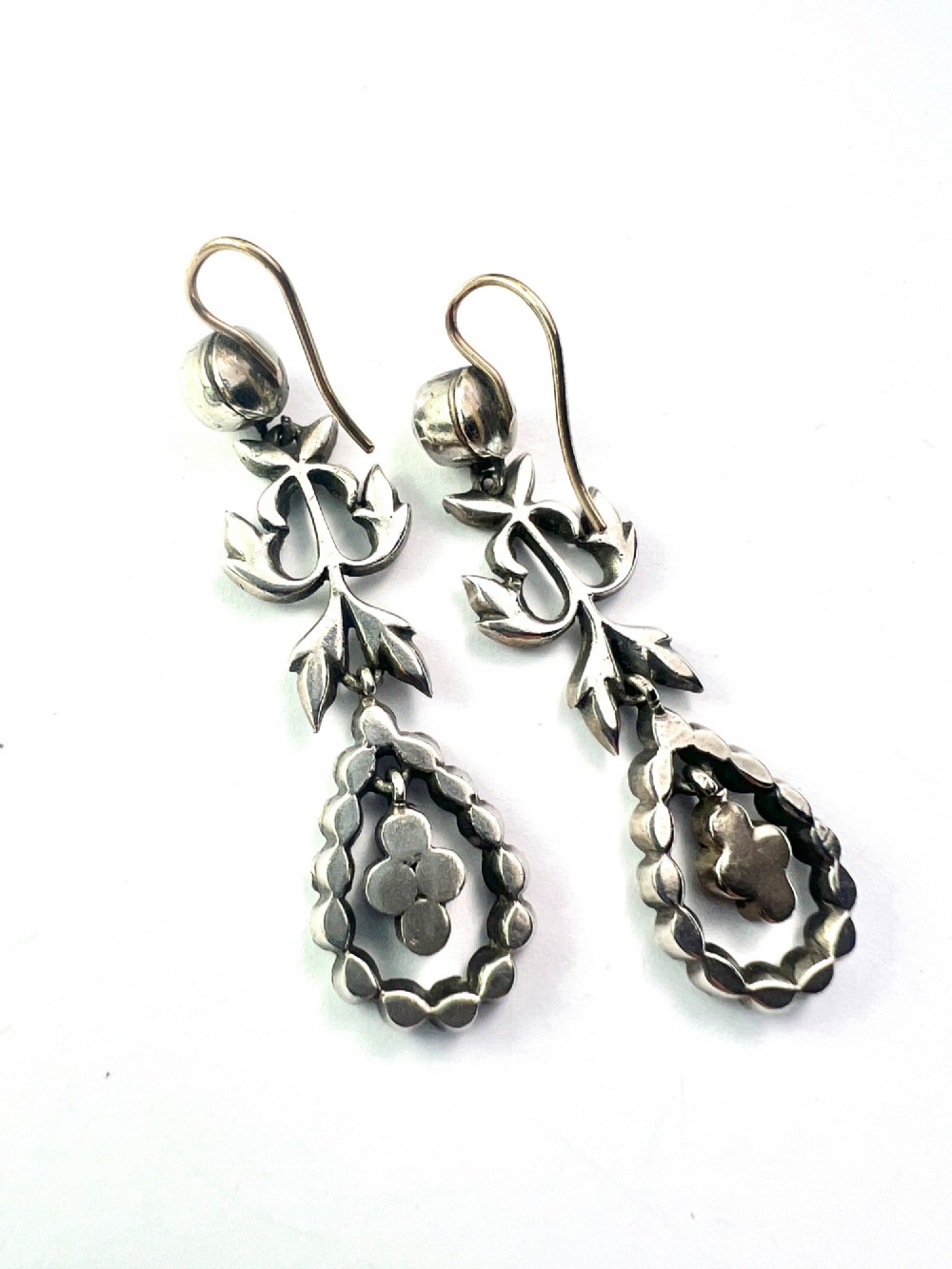 Pair of nineteenth-century silver drop earrings set with clear faceted paste glass stones in an articulated chandelier motif. View III