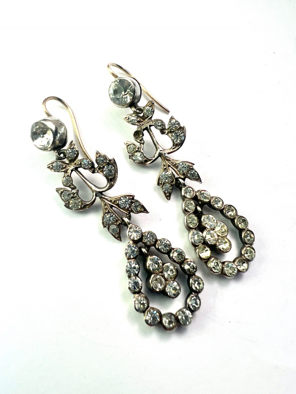 Pair of nineteenth-century silver drop earrings set with clear faceted paste glass stones in an articulated chandelier motif. View IV