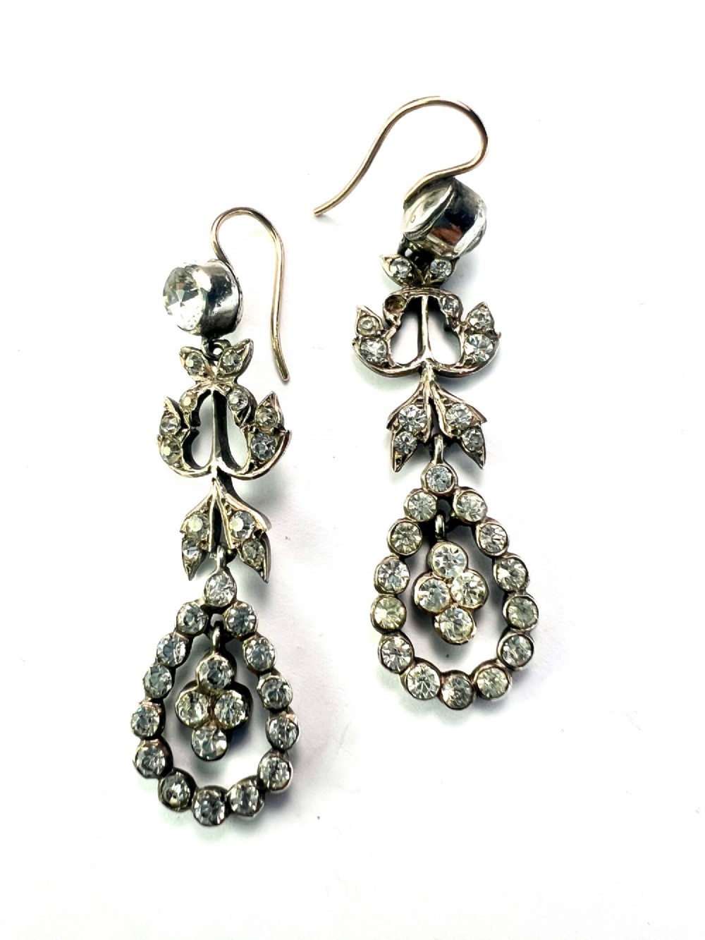 Pair of nineteenth-century silver drop earrings set with clear faceted paste glass stones in an articulated chandelier motif. View V