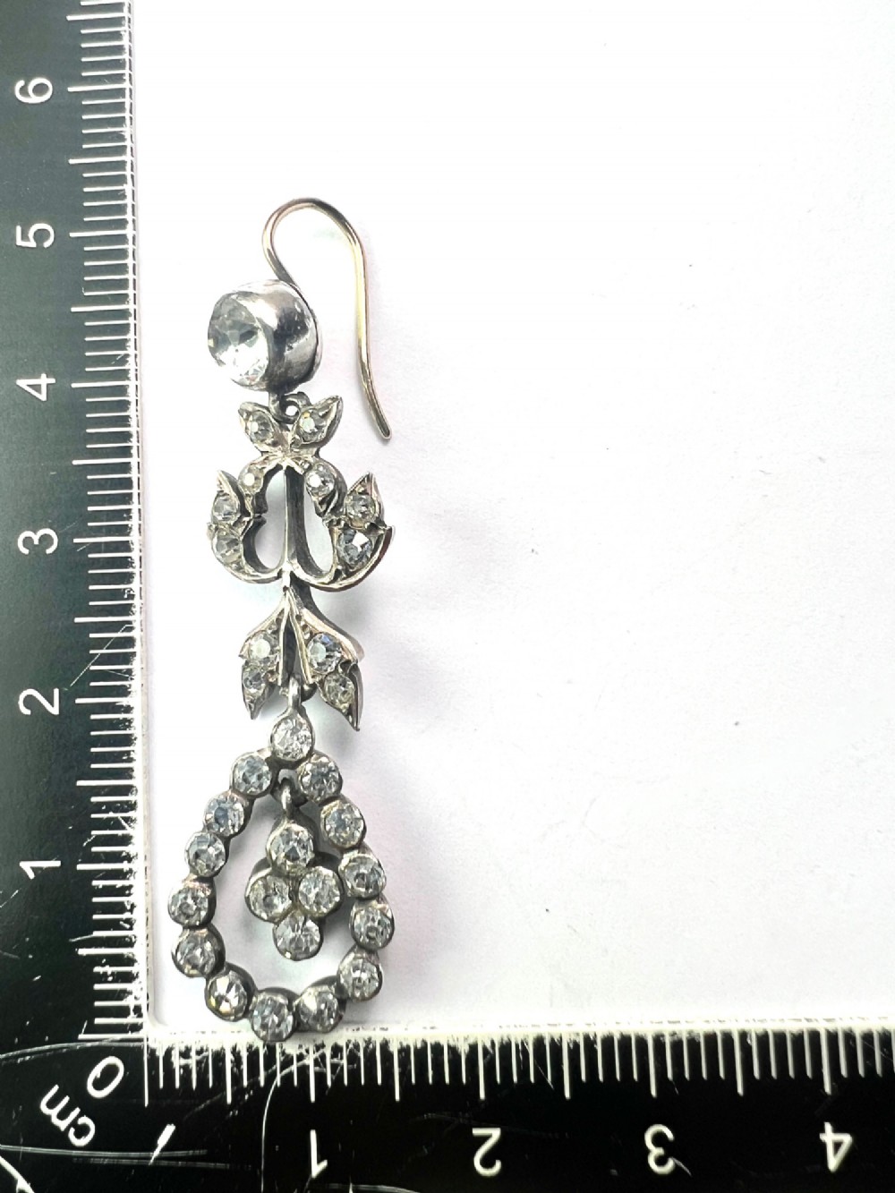 Pair of nineteenth-century silver drop earrings set with clear faceted paste glass stones in an articulated chandelier motif. View VI
