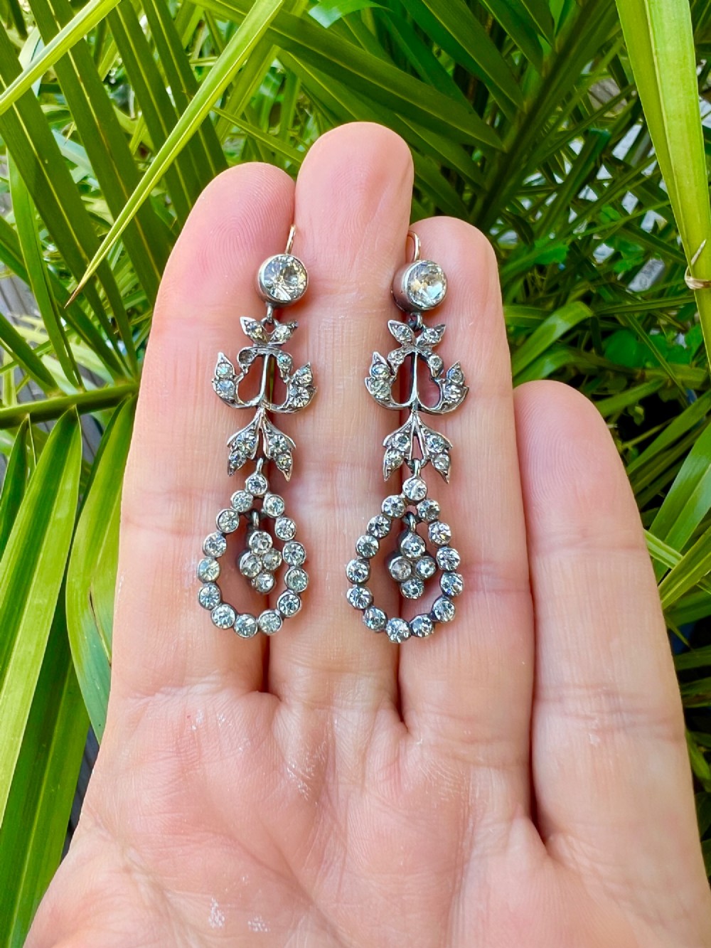 Pair of nineteenth-century silver drop earrings set with clear faceted paste glass stones in an articulated chandelier motif. View VII