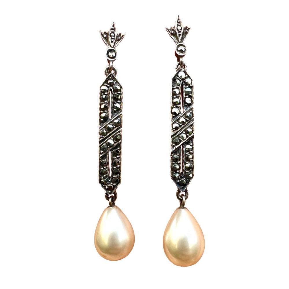 Pair of Art Deco silver drop earrings featuring geometric marcasite-set panels suspended above cream teardrop pearls.