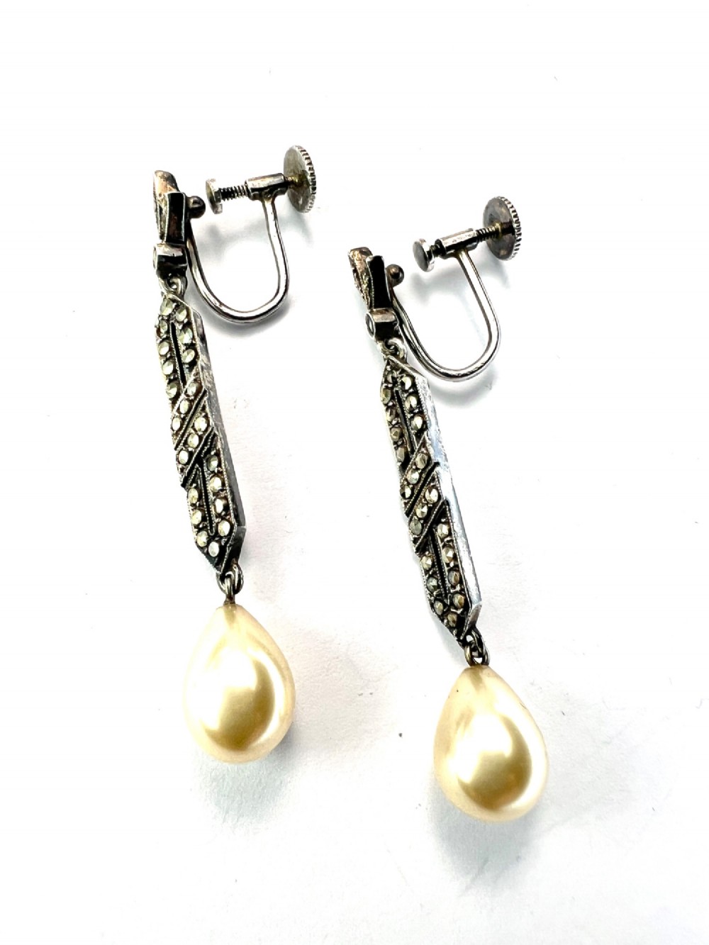 Pair of Art Deco silver drop earrings featuring geometric marcasite-set panels suspended above cream teardrop pearls. View II