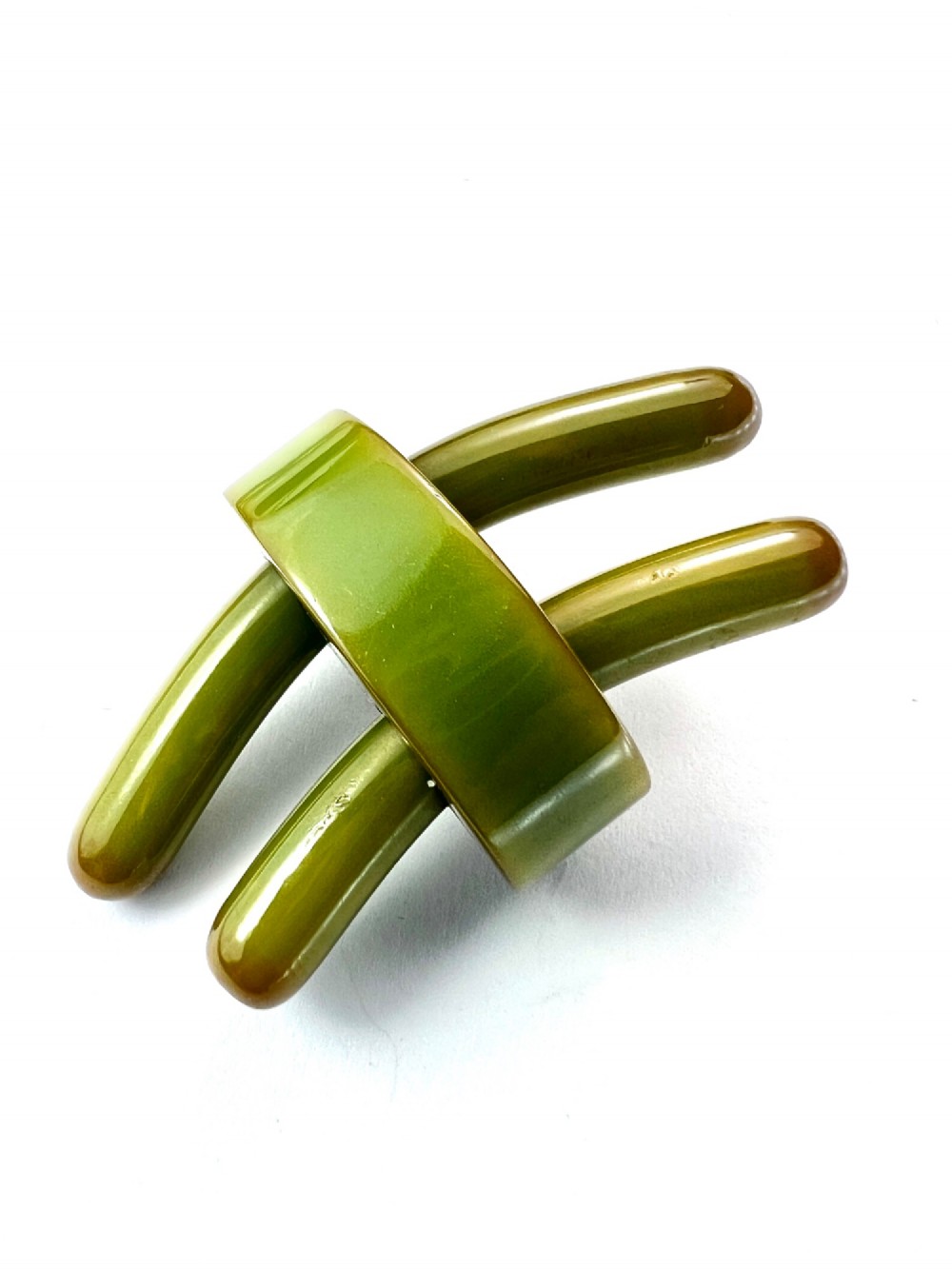 An Art Deco olive green Bakelite brooch featuring curved geometric bars joined by a central band. View IV