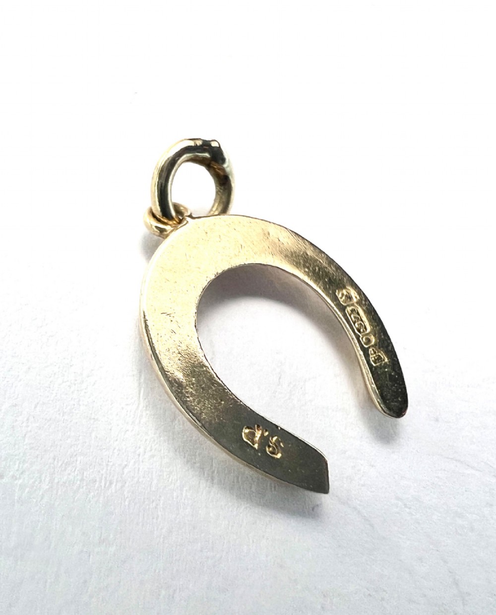 A vintage 9ct yellow gold horseshoe charm pendant featuring realistic nail detail impressions and a top suspension ring. View III