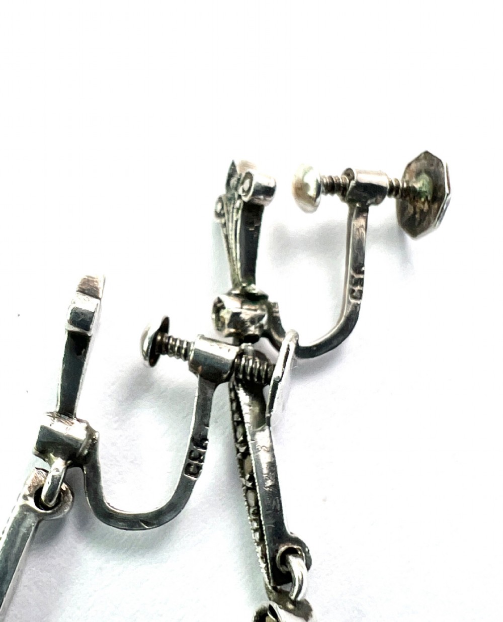 A pair of vintage sterling silver drop earrings featuring faceted teardrop citrine stones suspended from articulated marcasite-set links. View V