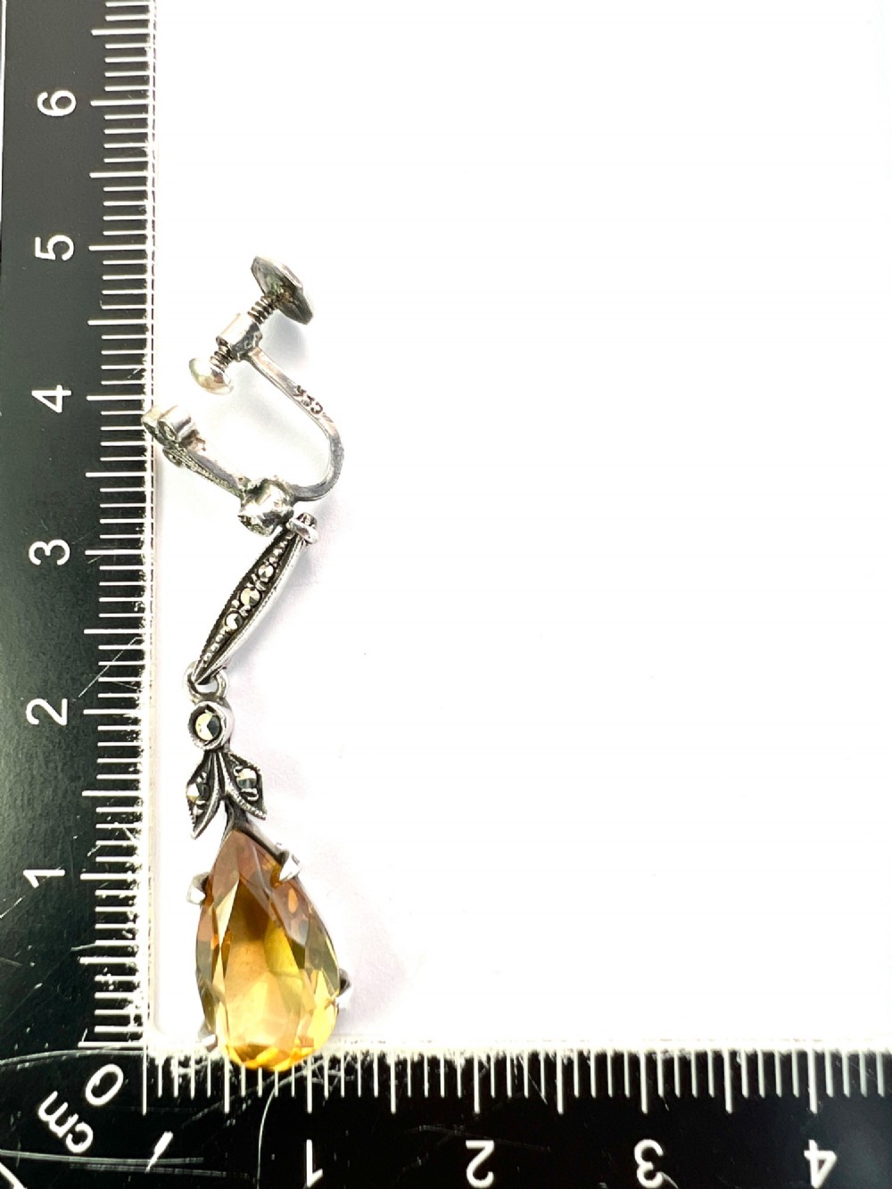 A pair of vintage sterling silver drop earrings featuring faceted teardrop citrine stones suspended from articulated marcasite-set links. View VI
