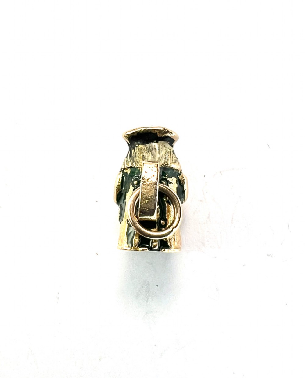 A miniature 9ct gold and enamel Toby jug charm depicting a seated figure in a tricorn hat with red and black painted details. View III
