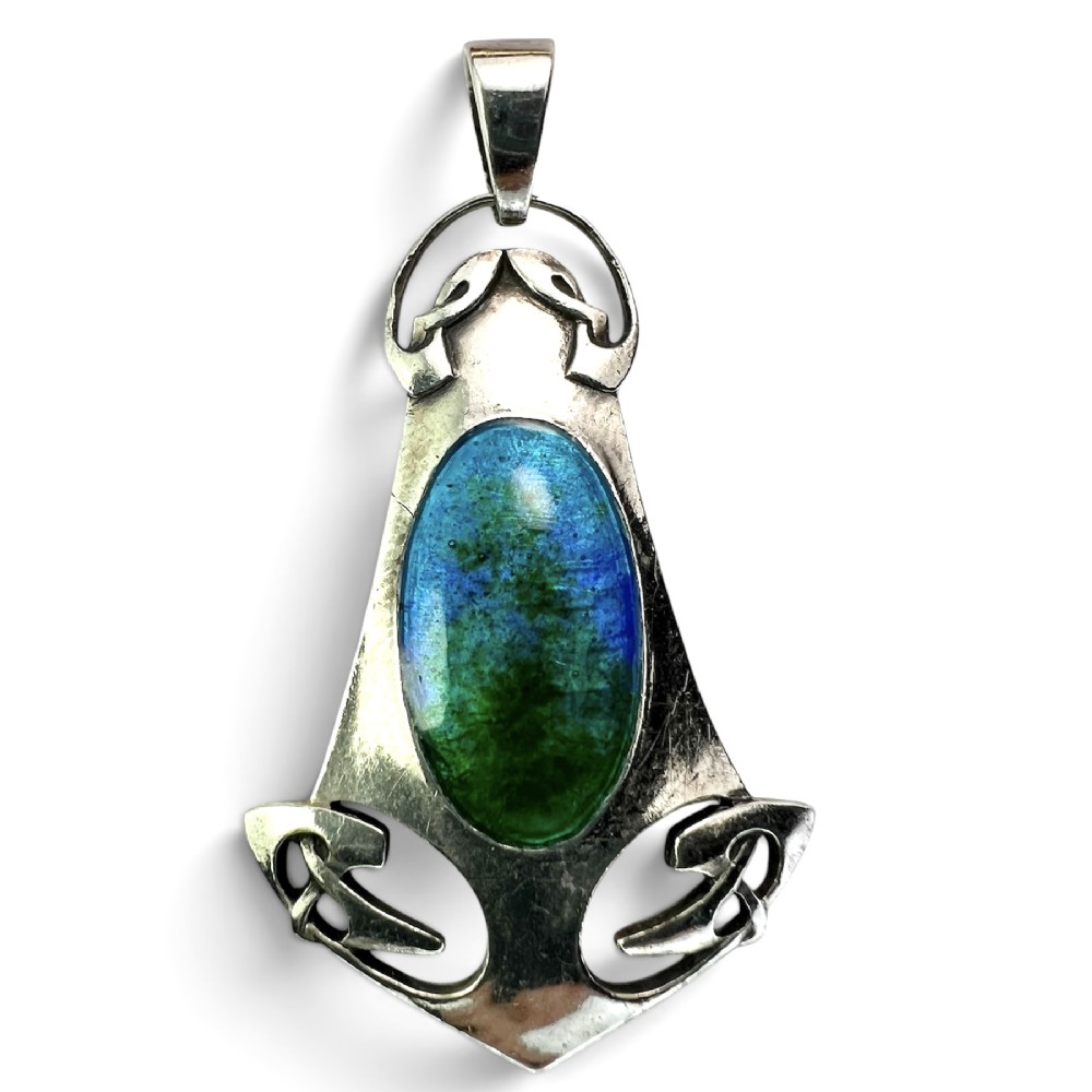 A silver Arts and Crafts style openwork pendant featuring stylised Celtic knots around a central oval blue and green enamel insert.