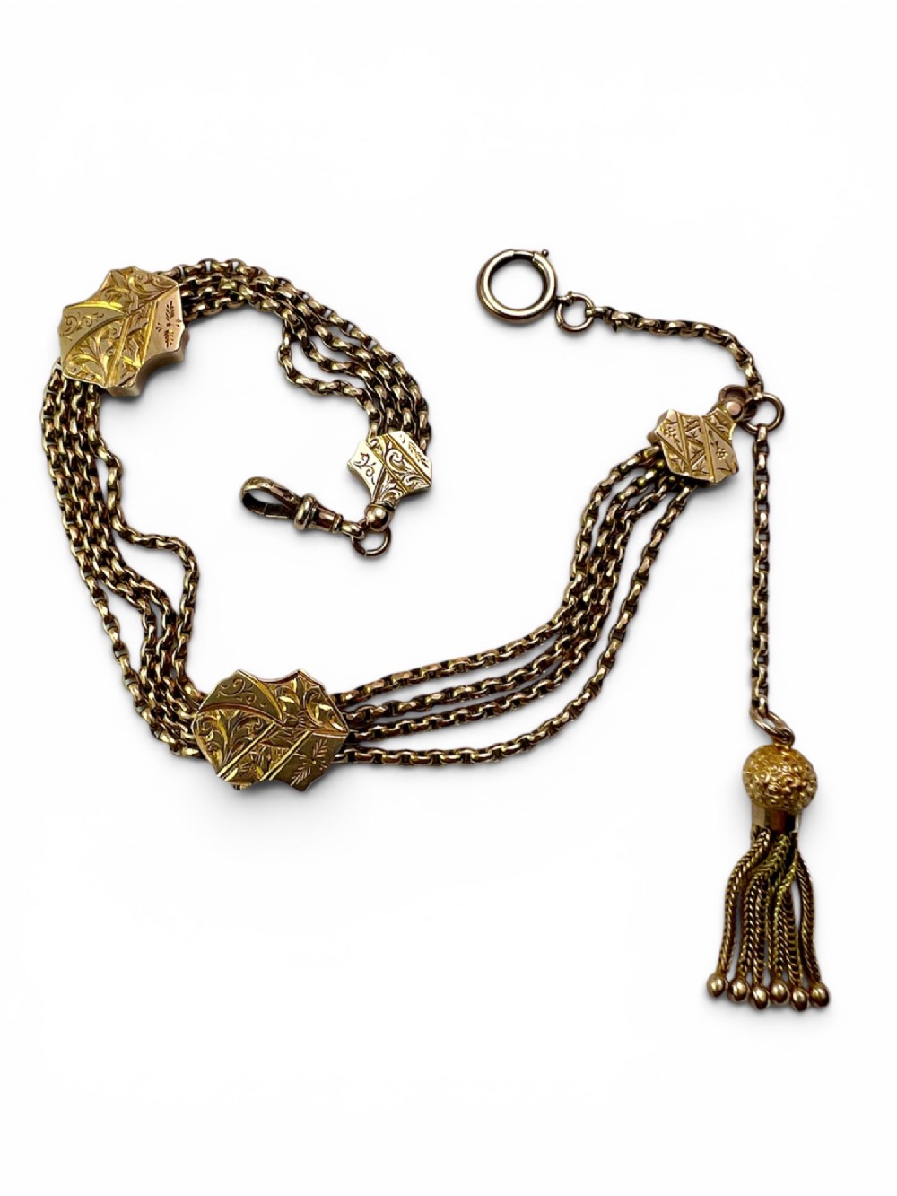 An antique 9ct yellow gold Albertina watch chain featuring four strands, decorative engraved slides, a swivel clasp, and a dangling tassel. View III