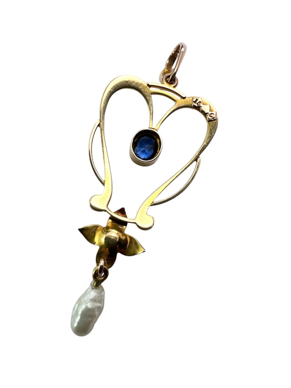 An Art Nouveau 15ct gold openwork lavalier pendant set with seed pearls, a central oval sapphire, and a hanging baroque pearl drop. View VI