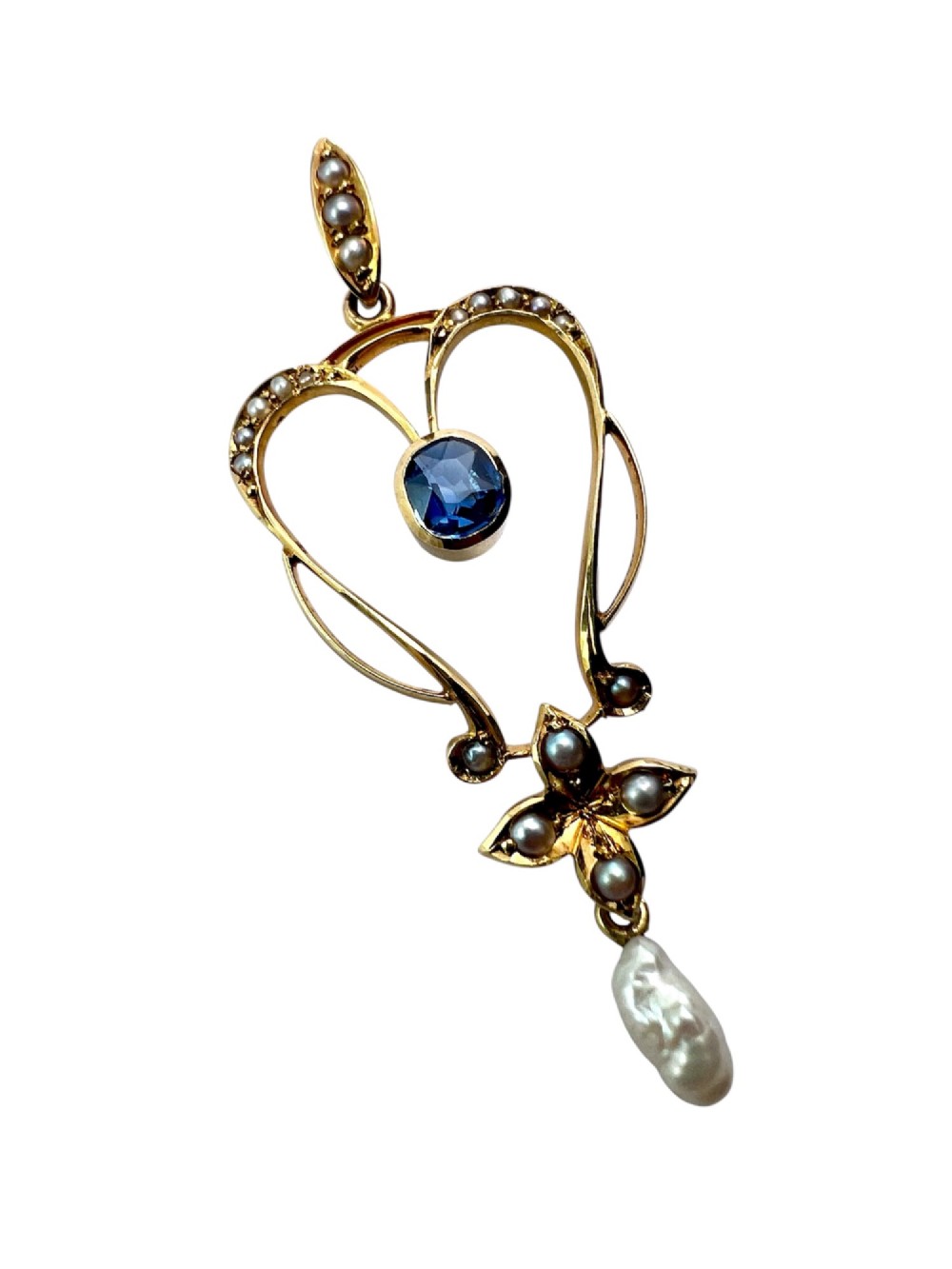 An Art Nouveau 15ct gold openwork lavalier pendant set with seed pearls, a central oval sapphire, and a hanging baroque pearl drop. View VII