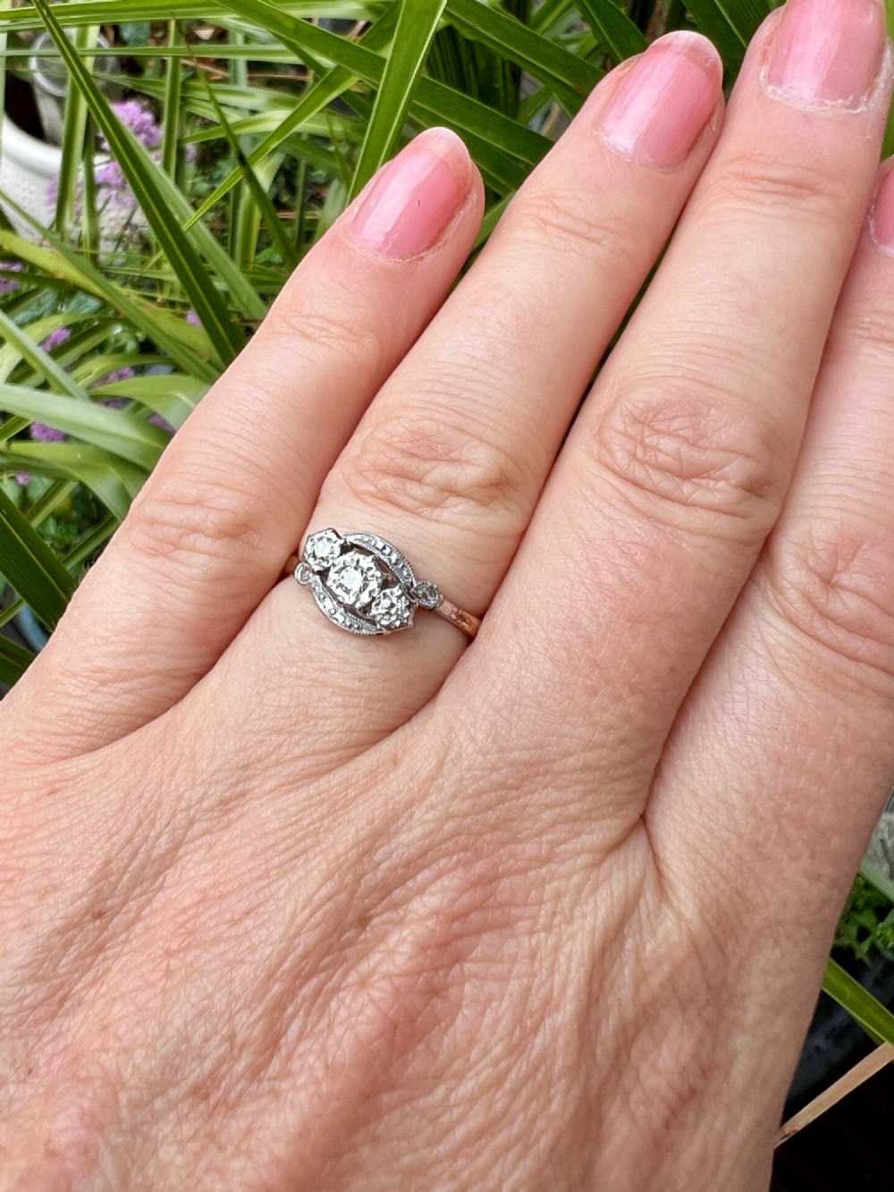 A vintage 18ct yellow gold and platinum ring featuring three small diamonds set in an ornate crossover mount with millegrain detailing. View III