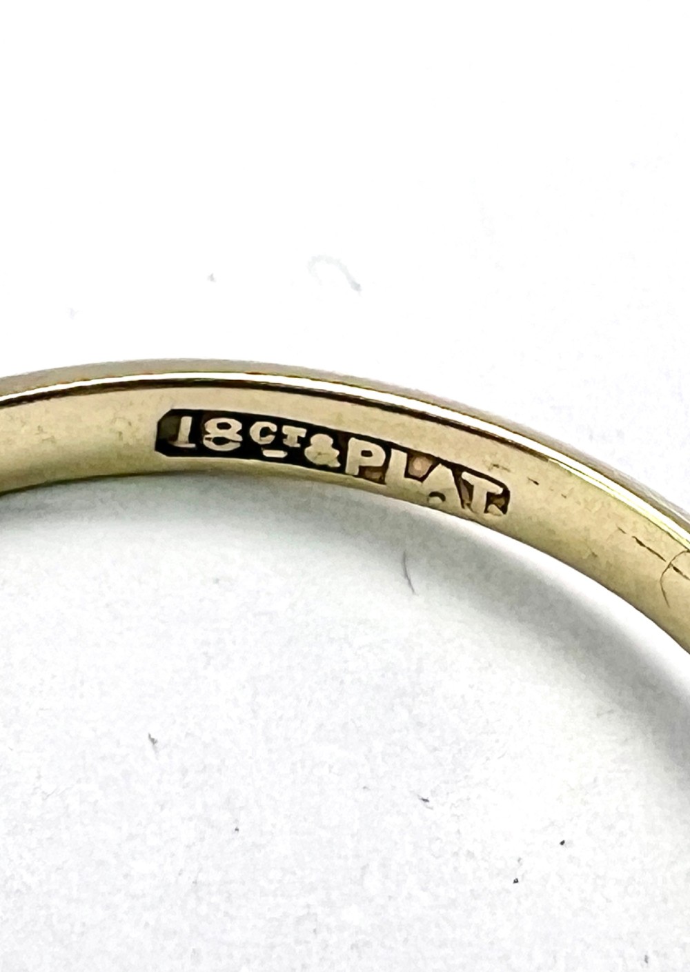 A vintage 18ct yellow gold and platinum ring featuring three small diamonds set in an ornate crossover mount with millegrain detailing. View V