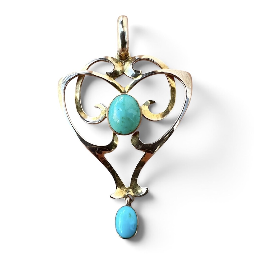 An Art Nouveau 9ct yellow gold openwork heart-shaped pendant set with a central turquoise cabochon and a dangling oval turquoise stone.
