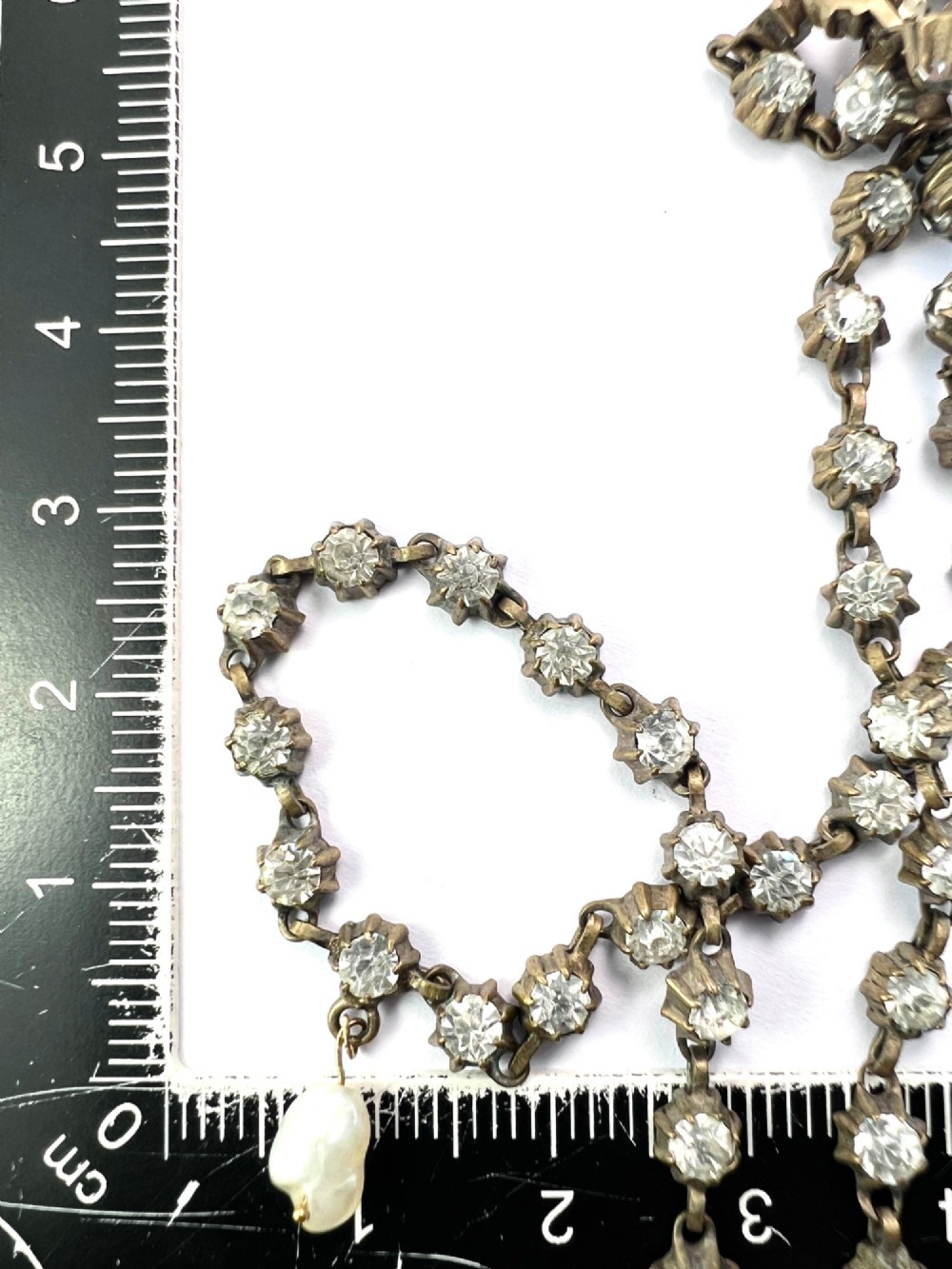 A Victorian silver-tone chain linked with round faceted paste glass stones and featuring a singular natural pearl drop at the centre. View III