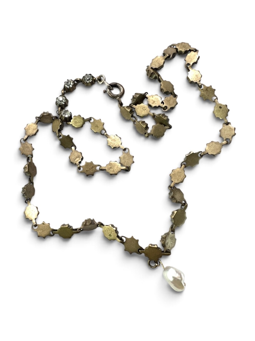 A Victorian silver-tone chain linked with round faceted paste glass stones and featuring a singular natural pearl drop at the centre. View VI