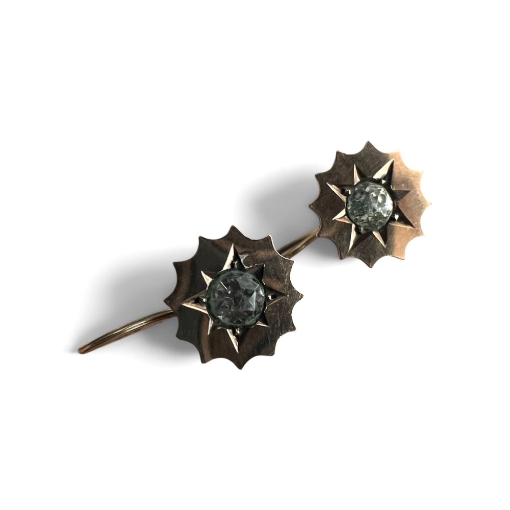 A pair of Victorian gold drop earrings featuring starburst-engraved settings with central clear round paste stones and shepherd hook fastenings. View II